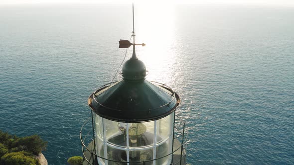 Close up view of top of lighthouse at sunset.