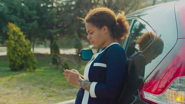 Woman Web Surfing on Phone for Roadside Assistance