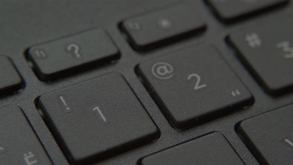 The Finger Presses a Button with a Number on the Keyboard