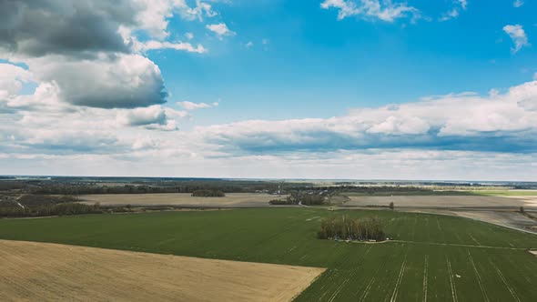 Clouds In Sky Above Countryside Rural Field Landscape In Spring Summer Day