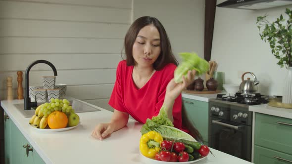 Portrait of Young Asian Woman Feeling Sad and Bored with Diet at Home