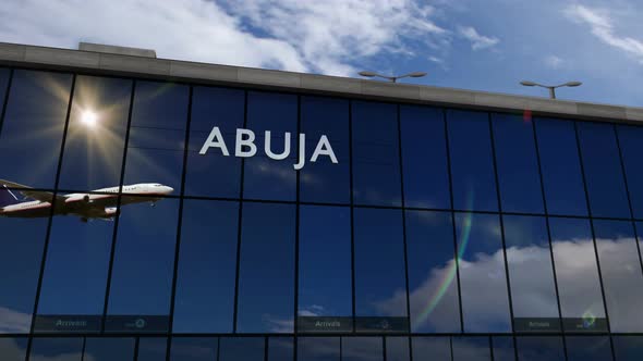 Airplane landing at Abuja Nigeria airport mirrored in terminal