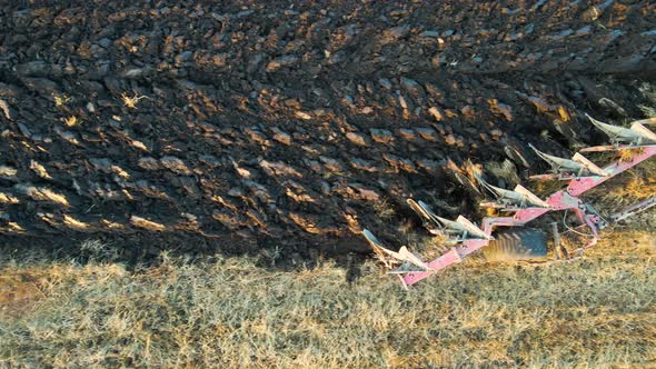 Aerial View of a Tractor Plowing Agricultural Farm Field