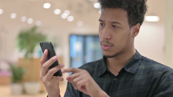 African American Man Checking Smartphone