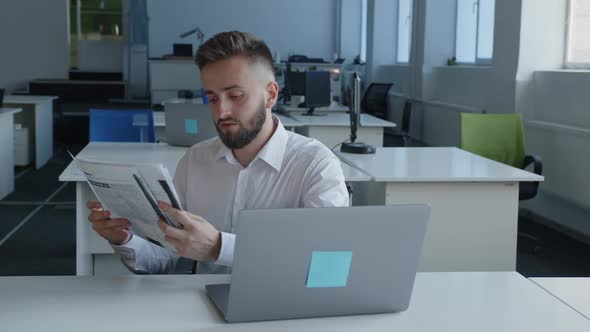 Young Man Looks Through All the Paper Work