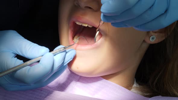 Close-up of a little girl's open mouth at the dentist during a dental check up