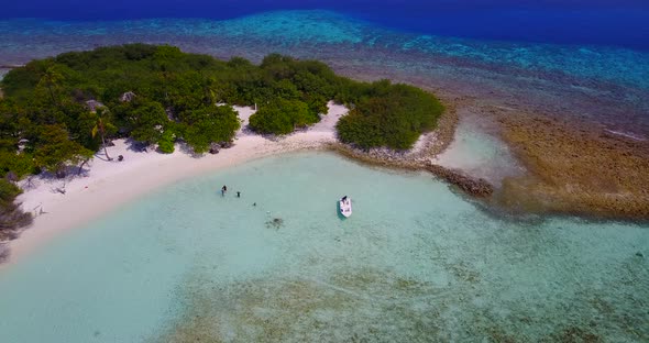 Luxury flying clean view of a white sand paradise beach and aqua blue water background in 4K