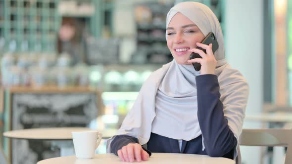 Cheerful Young Arab Woman Talking on Smartphone 