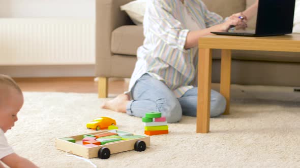 Working Mother and Baby Boy Playing at Home Office 15