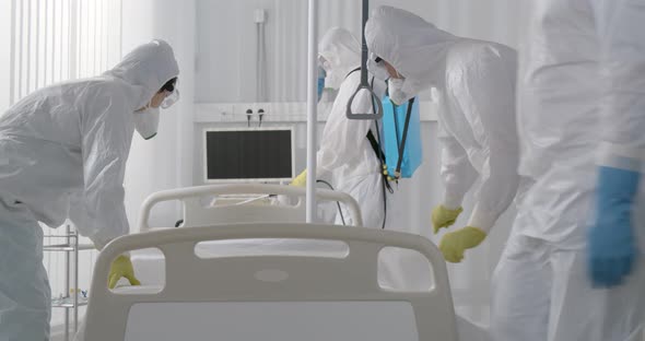 Medical Staff in Ppe Suit Disinfecting Hospital Ward and Changing Bedsheets