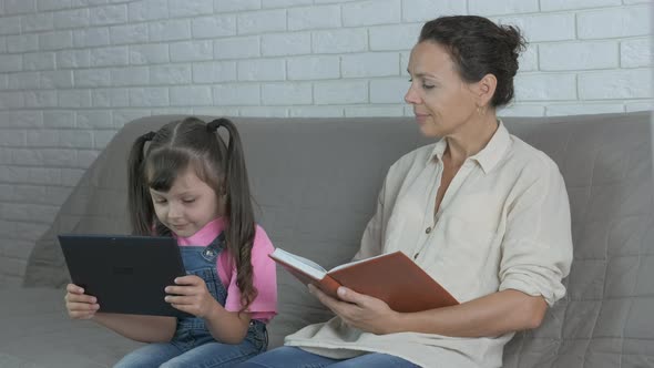 Watch a e book. Woman read a book in the bed. 