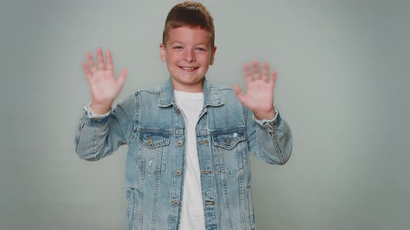 Toddler Boy Smiling Friendly at Camera and Waving Hands Gesturing Hello or Goodbye Welcoming