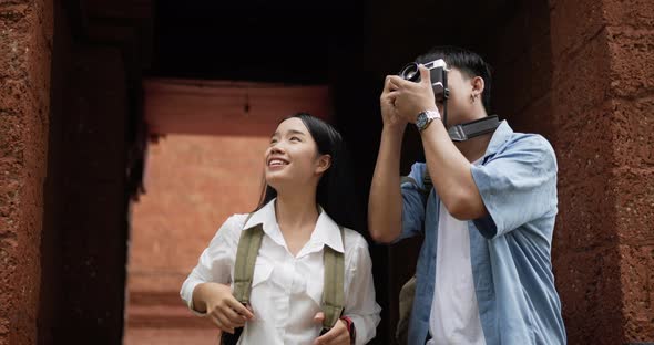 Couple takes a photo and visits ancient temple