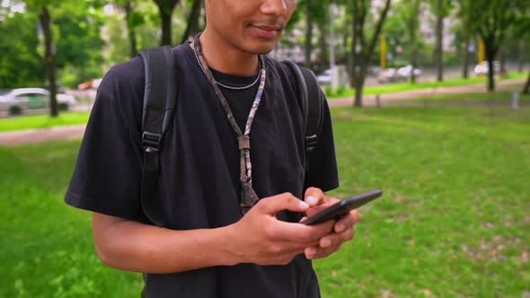 Portrait Guy Typing Message on Mobile Outdoors