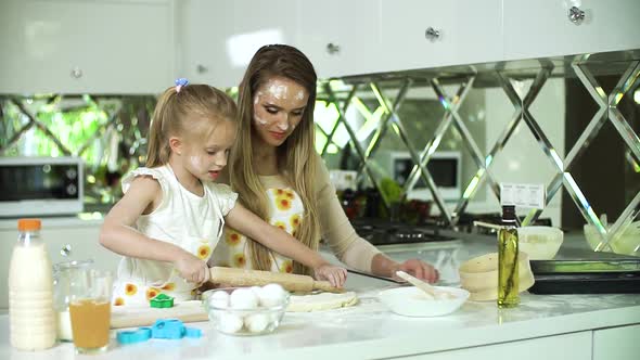 Woman With Daughter Cooking, Baking Together At Kitchen