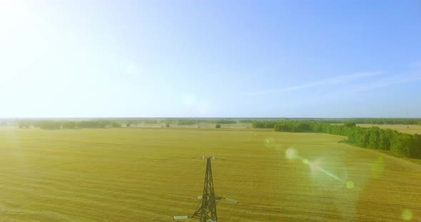 Vertical Movement Flight Near High Voltage Electricity Tower and Power Lines at Green and Yellow