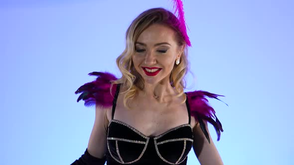 Gorgeous Sexy Burlesque Dancers Pose Against the Backdrop of a Large Black Cake