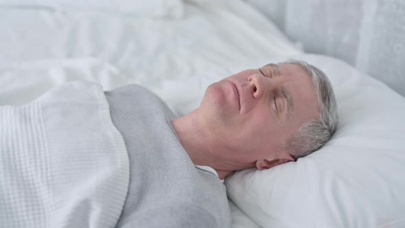 Senior Old Man Sleeping in Bed and Having Nightmare