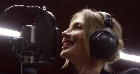 Beautiful Woman Sings a Love Song in Recording Studio