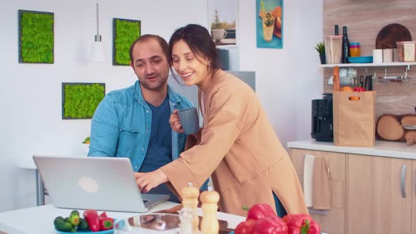 Woman Looking at Husband Laptop