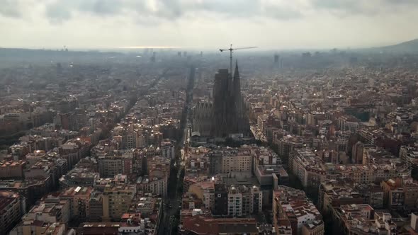 Aerial drone view of Barcelona, Spain. Blocks with multiple residential buildings and Sagrada Famili