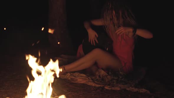 Beautiful Young Hippie Woman with Dreadlocks Playing on Djembe