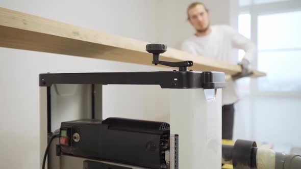 Carpenters Working with Wood on the Planing Machine