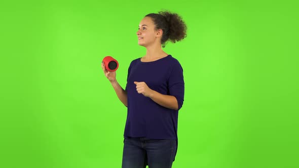 Curly Listening To Music with Bluetooth Portable Speaker and Dancing . Green Screen