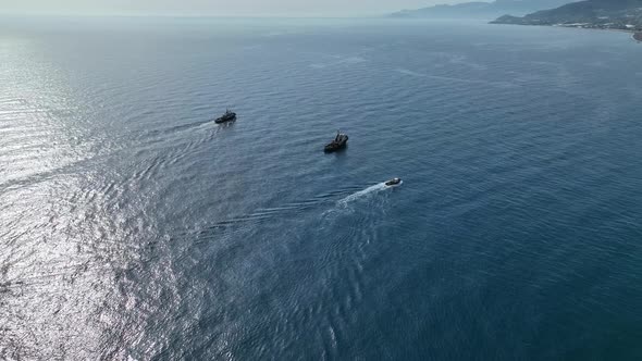 Tugs help the gas tanker to go to sea aerial view 4 K Turkey Alanya