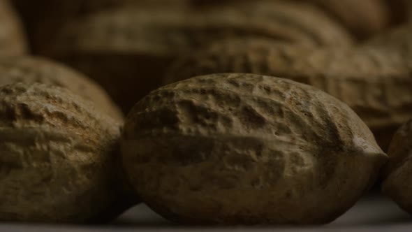 Cinematic, rotating shot of peanuts on a white surface - PEANUTS 016