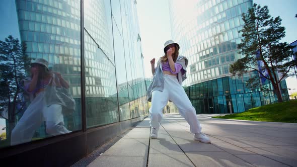 Fashionable Funky Caucasian Girl Dancer in Sportswear is Performing Outdoor Street Dancing Motion