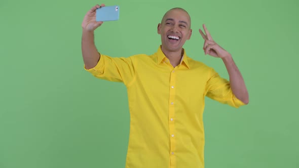 Happy Handsome Bald Businessman Taking Selfie with Phone