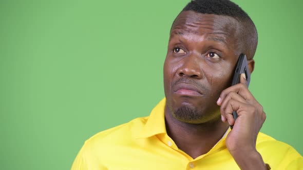 Young Happy African Businessman Thinking While Talking on the Phone