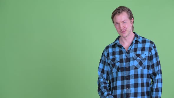 Happy Young Hipster Man Touching Something and Giving Thumbs Up