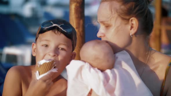 Mother with Baby and Elder Son at the Beach