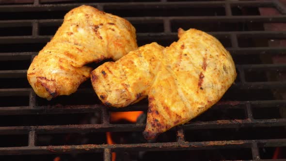 Closeup of the Chicken Fillet Roasting on the Grill Grid