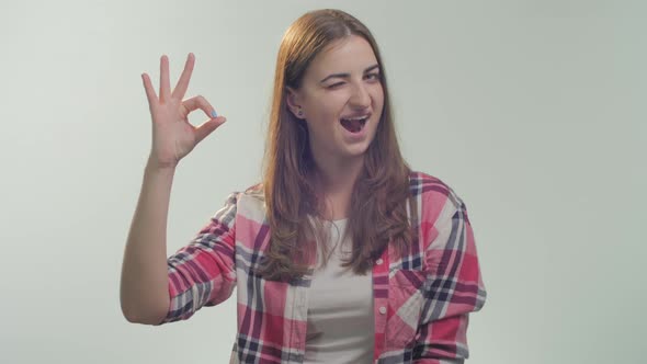 Woman shows OK hand sign