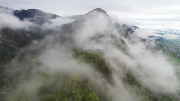 Flying over misty mountains and hills