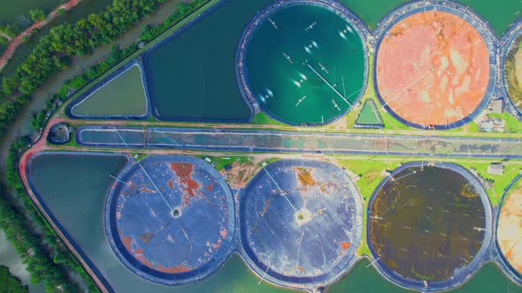 An aerial view of a drone flying over a large shrimp farm