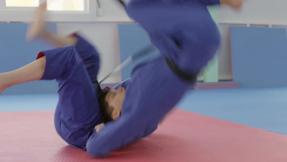 Strong Female Jujitsu Athlete Fighting with Male Partner