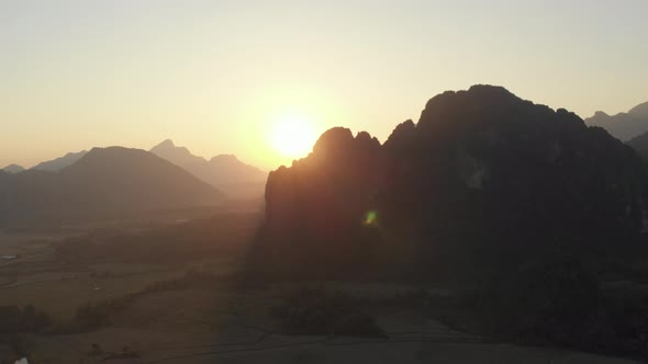 Aerial: Vang Vieng backpacker travel destination in Laos, Asia.