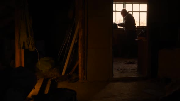 Elderly Man Glasses Read Book in Attic Loft House Window