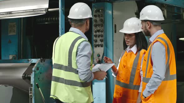 Inspector Making Notes on Work of Machinery