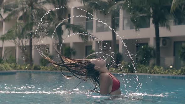 Joyful Girl in Bikini Throws Hair Back in Pool Slow Motion