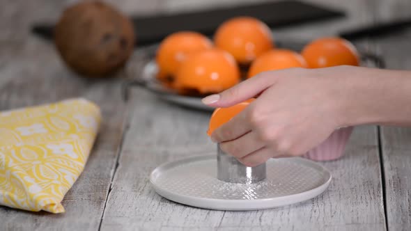 Orange tropical mousse cake decorate with coconut flakes. Modern european cake pastry.