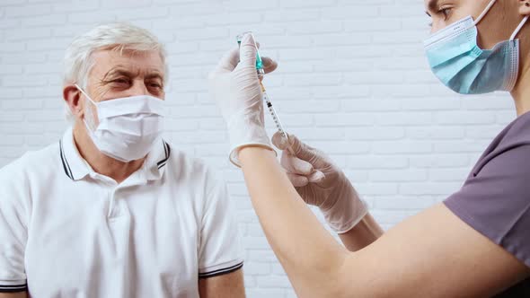 Nurse Preparing Syringe with Medicine for Patient