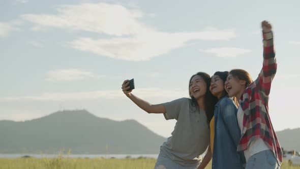 Group of a young Asian woman taking selfies having fun together a summer traveling.