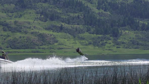 Young man wake boarding on a lake.