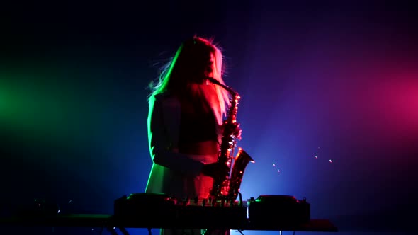 Young Sexy, Blonde Woman Dj, Bending, in White Jacket and Black Top Playing Music Using Saxophone