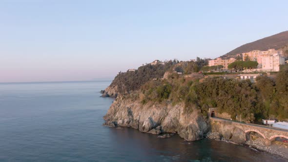 Mediterranean drone shot of a beautiful sunrise at some cliffs at the west coast of italy